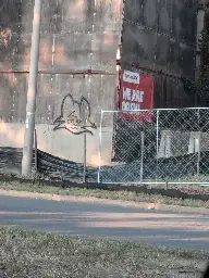 Boykisser fella spray painted onto a construction wall.