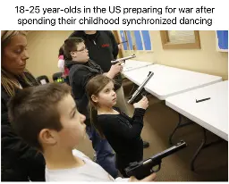 Pictured: Three kids holding hand guns and looking apprehensive face a line of plastic picnic tables against a wall. Two adults stand behind the kids. 

Caption: 18-25 year-olds in the US preparing for war after spending their childhood synchronized dancing